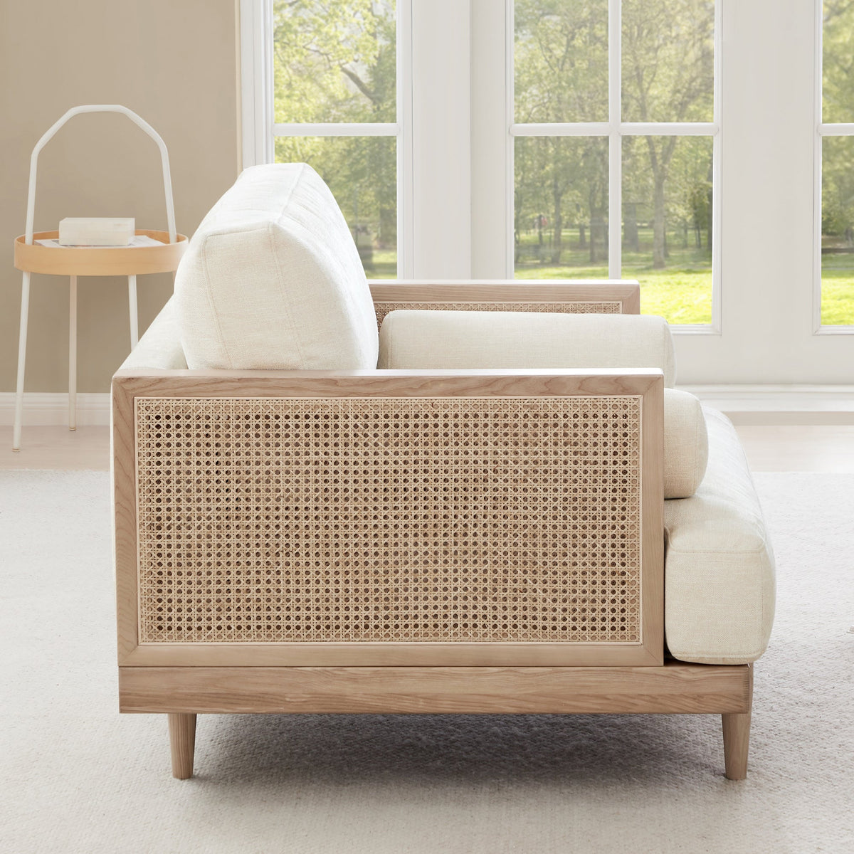 Julane cane armchair side view, featuring light fabric and natural cane backrest - CHITA Living