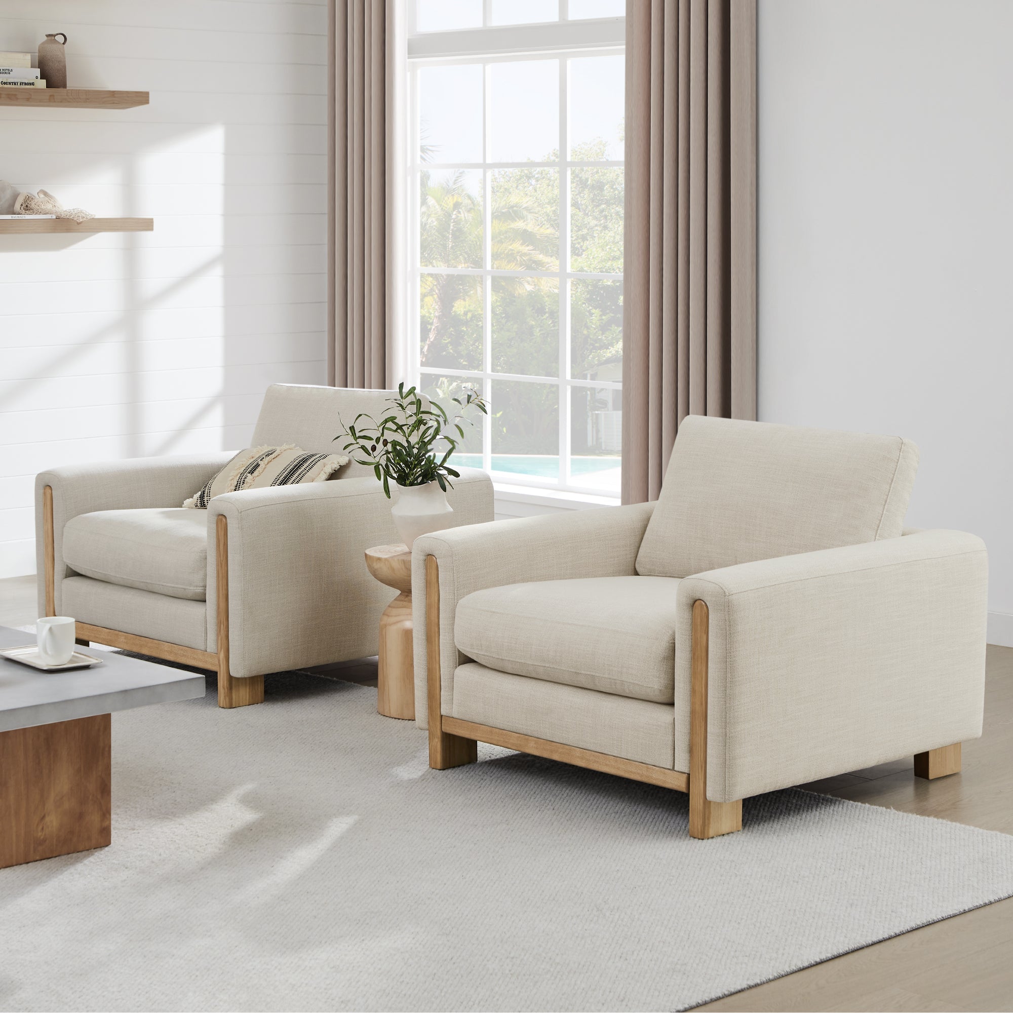 Modern Keaton Armchairs with natural wood base and plush cushions in a sunny room - CHITA Living
