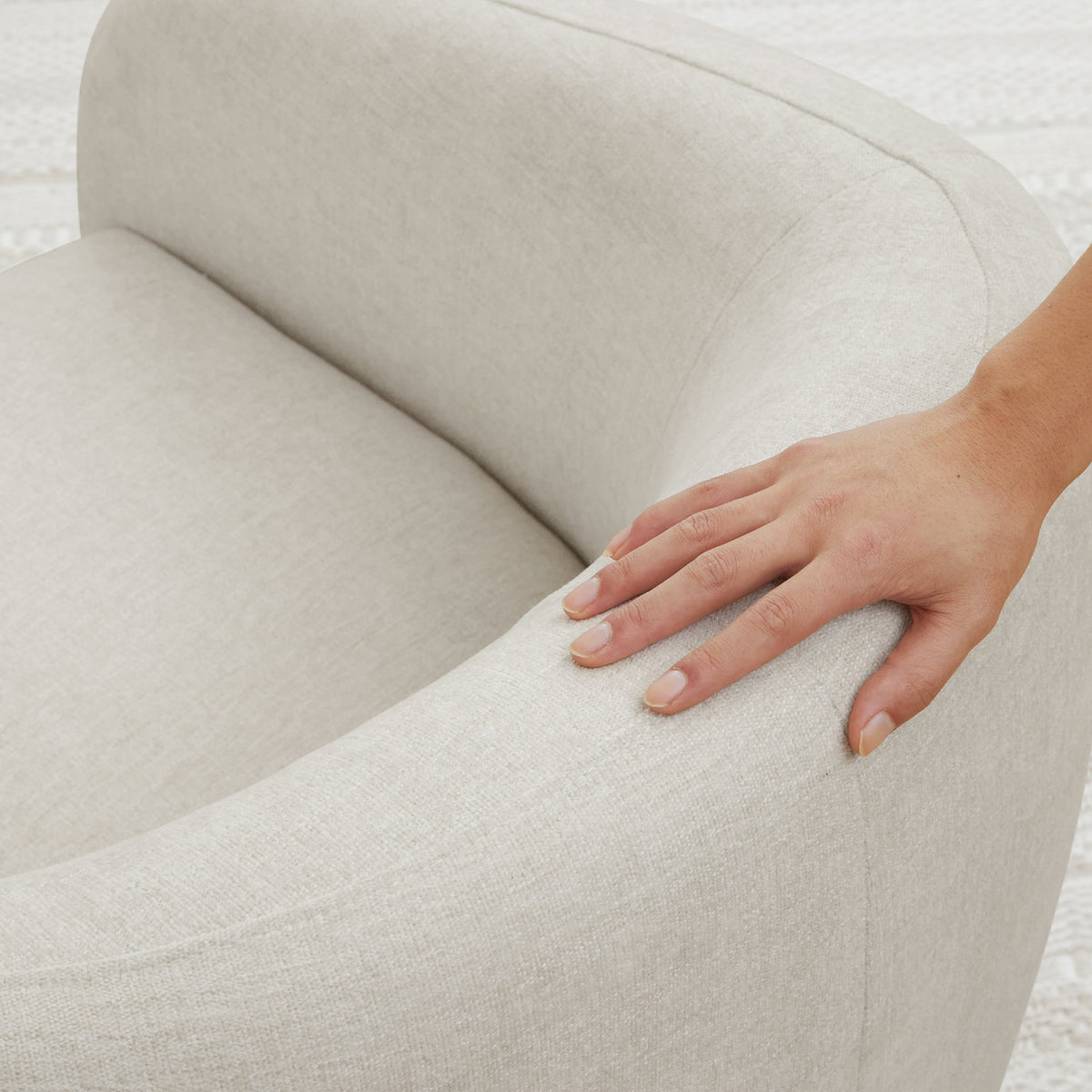 Close-up of light gray Bella Modern Swivel Accent Chair armrest showing plush curved design - CHITA Living
