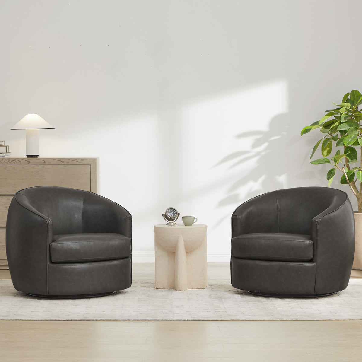 Modern swivel accent chairs in dark grey leather with cozy side table in bright room - CHITA Living